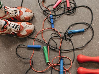 Close-up of gym shoes and a skipping rope.