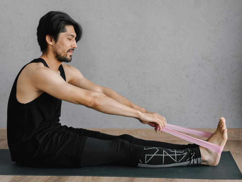 Detailed close-up of yoga mat and resistance bands on floor.
